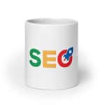 A SEO White Glossy Mug with the letters "seo" printed on it. the "s" is green, the "e" is yellow, and the "o" incorporates a blue magnifying glass design with a red handle.