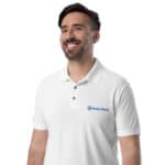 A smiling man wearing a white HR Signature Polo Shirt with a logo that says "hasty rank" on the left chest area. he has short dark hair and a neatly trimmed beard, presenting a cheerful expression.