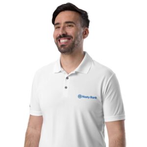 A smiling man wearing a white HR Signature Polo Shirt with a logo that says 