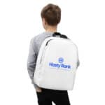 A boy wearing a gray hoodie stands with his back to the camera, carrying a HR Urban Voyager Backpack featuring the blue "hastyrank" logo and text stating "a fast-growing ranking company." the background is plain white.