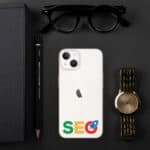 A flat lay image featuring a workspace theme with a white smartphone case labeled "SEO" on google's colored letters, accompanied by a gold watch, black-framed glasses, a black notebook, and a pencil, all on a dark background.