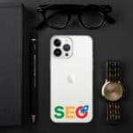 A flat lay featuring an iPhone with a "SEO Clear Case for iPhone®" with a google logo on the back, a notebook, a black pencil, sunglasses, and a gold wristwatch, all arranged on a dark surface.