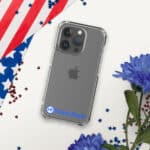 An Apple iPhone in a HR CrystalShield iPhone® Case, lying on a white surface scattered with red and blue stars, alongside part of an American flag and blue flowers.