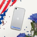 A HR CrystalShield iPhone® Case with a logo, placed on a white surface surrounded by an american flag, scattered red and blue confetti, and blue flowers.