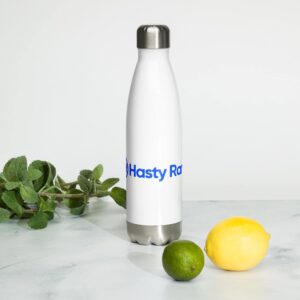 A white HR Elite Hydration Flask with the logo "hasty ros" in blue sits on a marble surface. to its left are fresh mint leaves, and to the right, a whole yellow lemon and a green lime.