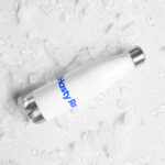 White reusable water bottle with "HR Elite Hydration Flask" logo in blue, lying on a wet surface covered with scattered ice cubes. the surface and bottle appear cool and refreshing.
