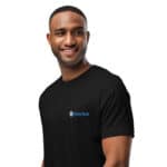 A smiling black man wearing a black HR PrimeStyle Tee with the "hasty rank" logo on the chest, depicted against a plain white background. he appears friendly and confident, looking directly at the viewer.