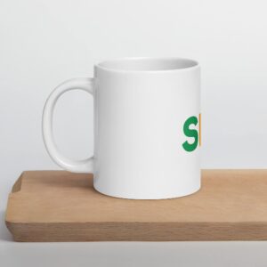 A SEO White Glossy Mug with a green letter "s" printed on it, sitting on a wooden board against a light gray background.