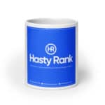 A HR Cheerful Brew Mug with a bright blue label featuring the logo "hr hasty rank" and text stating it's a full-service digital marketing and website design company, including a phone number and website url.